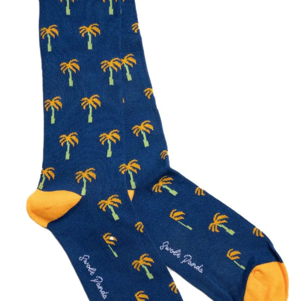 Navy blue bamboo sock with yellow palm trees featuring a contrasting toe and heel and brand logo swole panda on sole of foot