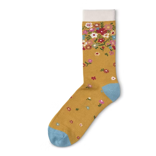 Floral-patterned sock on a mustard background