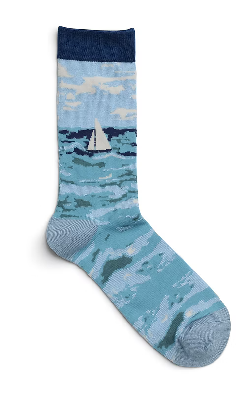 Sock with a nautical design featuring a sailboat on a blue background