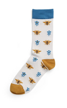 White sock with bee and flower pattern, blue cuff and yellow toe and heel