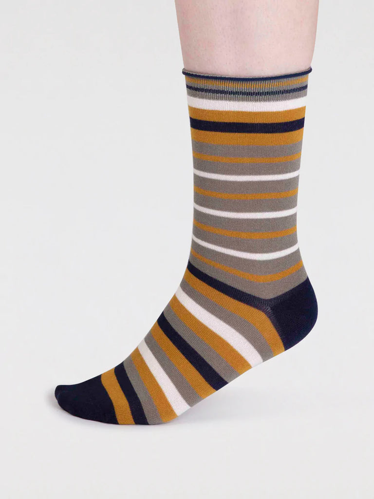 Side view of Orange, White, Beige and black striped organic cotton and bamboo sock by thought