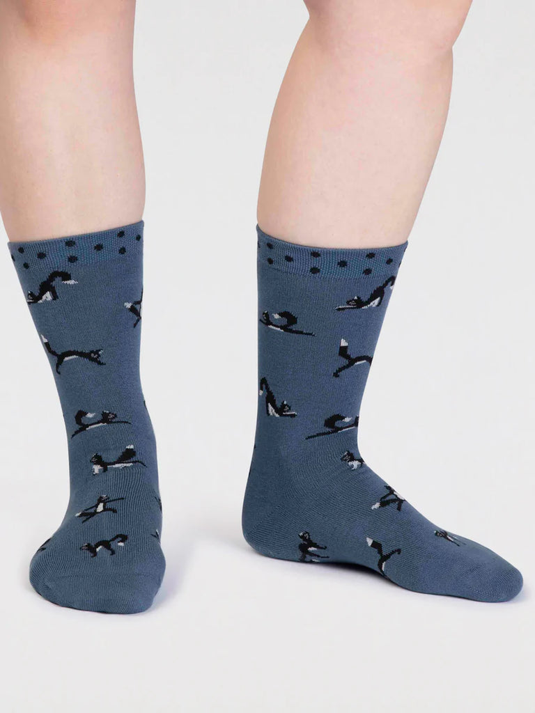 Misty Blue bamboo and cotton socks with a black cat in yoga positions print and black spots around the cuff