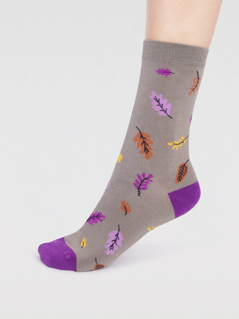 Olive grey bamboo socks with purple toe and heel and an orange, yellow and pink leaf pattern.