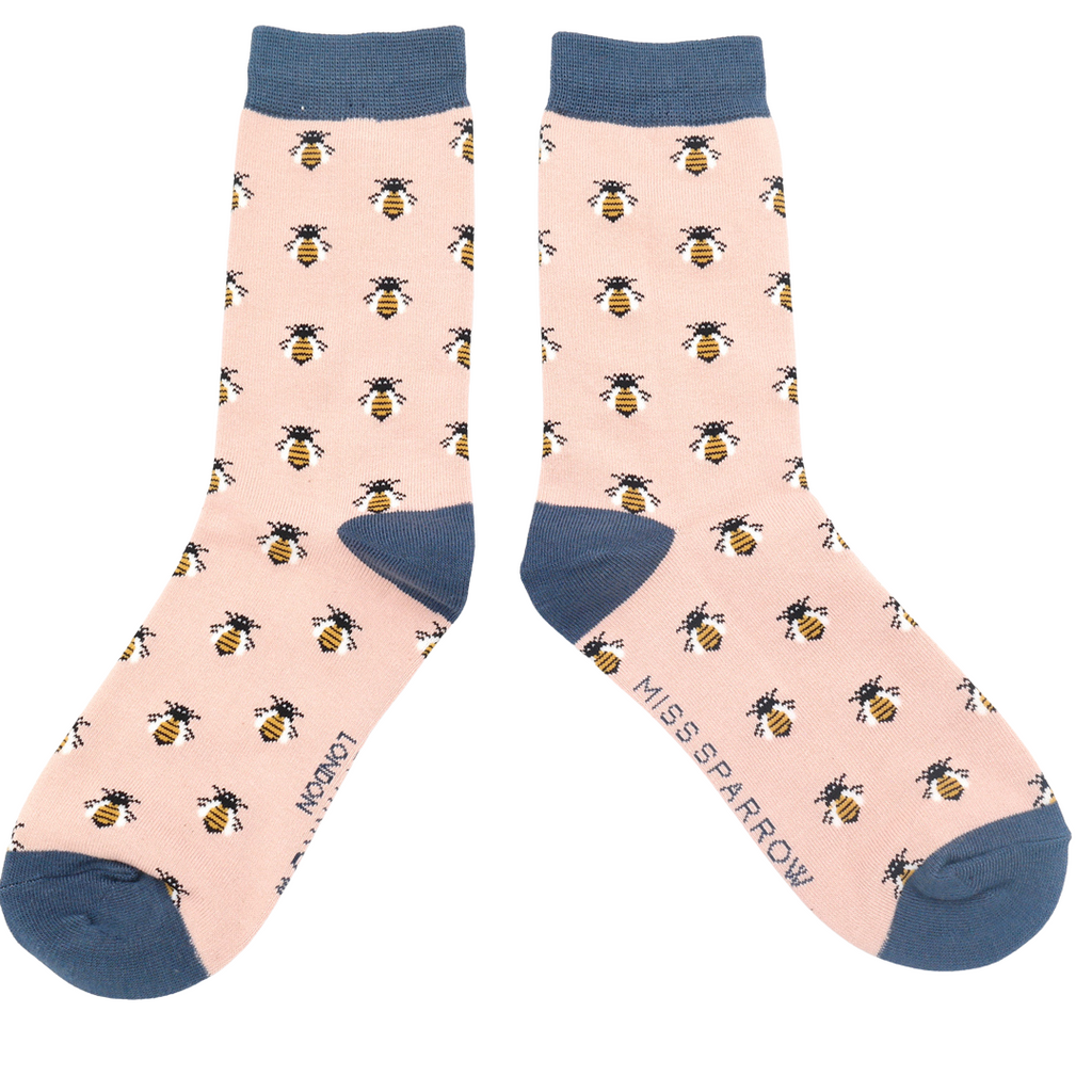 Baby pink bamboo socks with a contrasting blue toe and heel with a bumble bee print