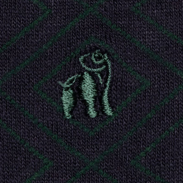 Close up of swole panda brand logo in green on navy diamond socks 