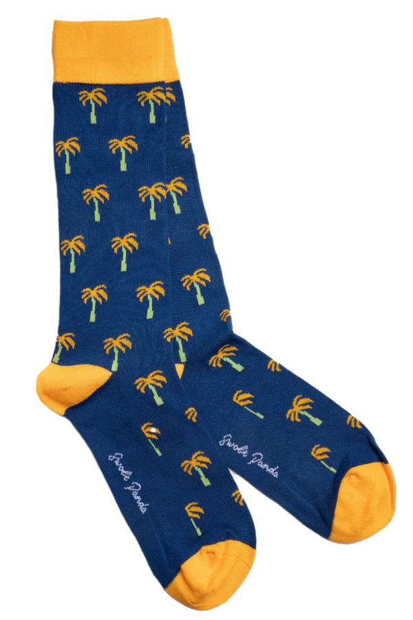 Navy blue bamboo sock with yellow palm trees featuring a contrasting toe and heel and brand logo swole panda on sole of foot