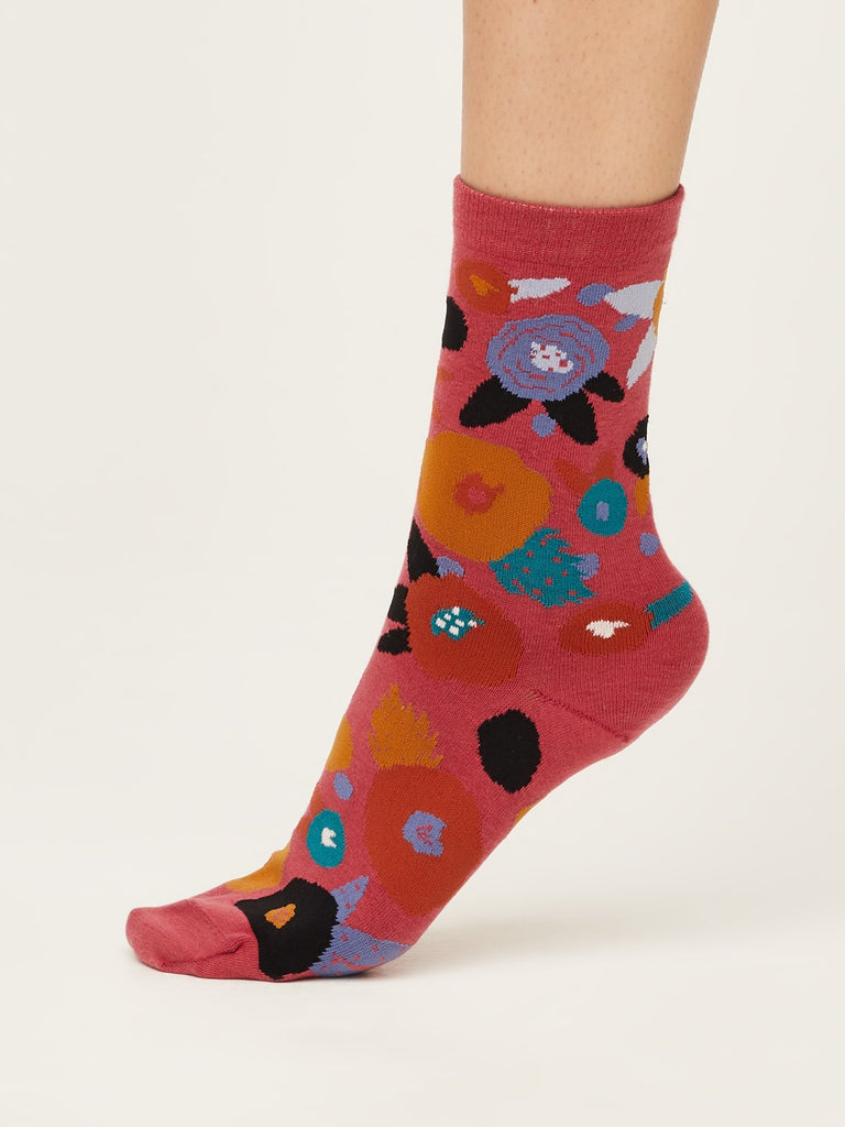 Side view of abstract floral super soft premium quality organic socks in blush pink with orange purple red and green flower design.