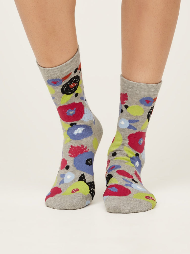 Front view of abstract floral super soft premium quality organic socks in grey marle with green black blue and red flower design.
